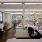 Two women looking into microscopes inside a crime laboratory operated by the Texas Department of Public Safety