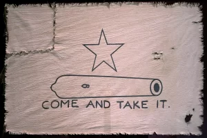 White flag showing a star, cannon, and the words "Come and Take It."