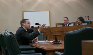 Mike Morath testifying to House committee in hearing room in Capitol Extension.