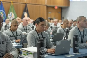 Recruits at the DPS Training Academy typing on laptops