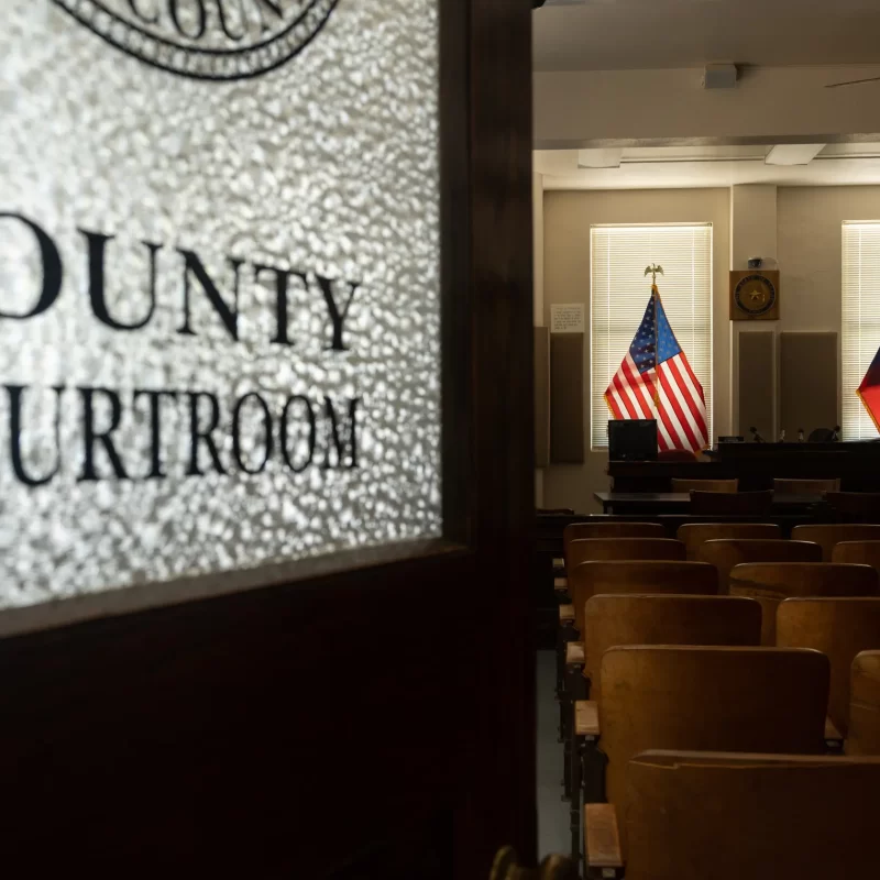 Door to county courtroom, flags in background