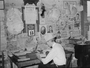 Old photo of grocery store owner doing accounting.