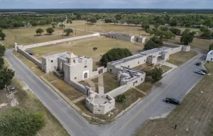 Aerial view of stone ruins and reconstructed fortifications at the Presidio La Bahía State Historic Site